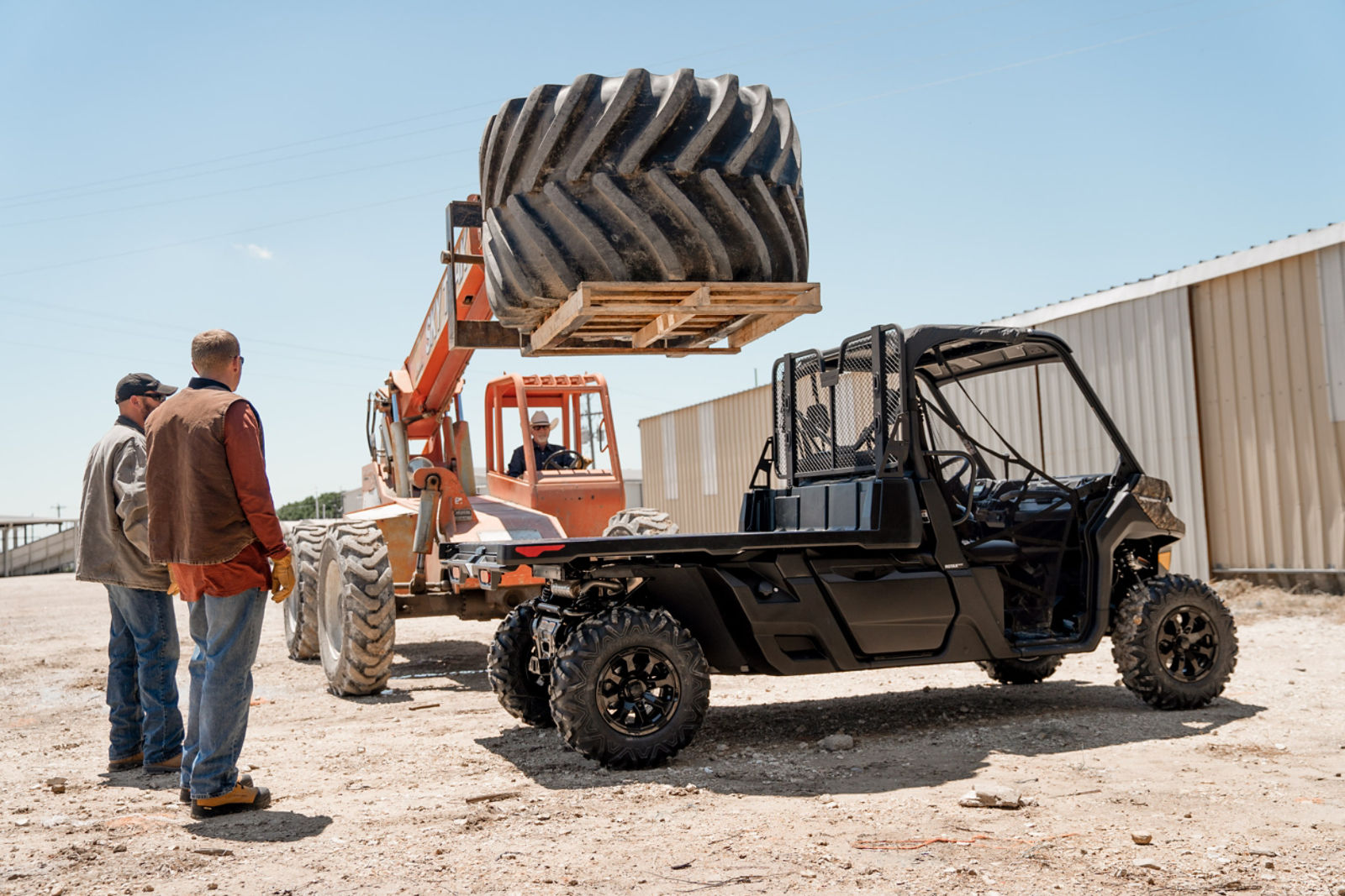 Construction workers working with a Defender model