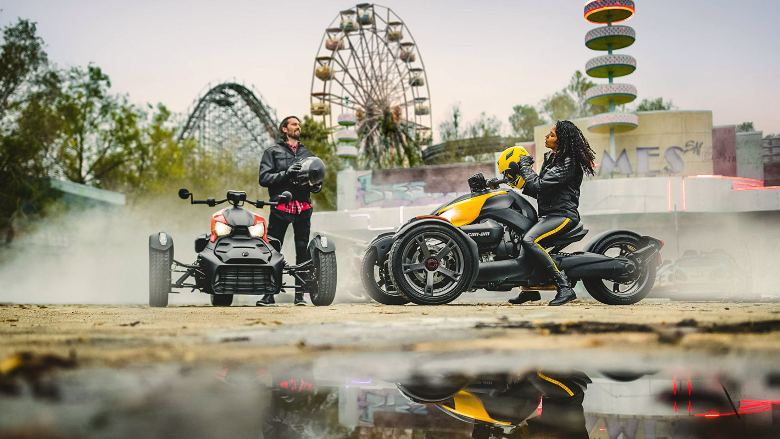 Couple riding Can-Am Ryker near a fun fair