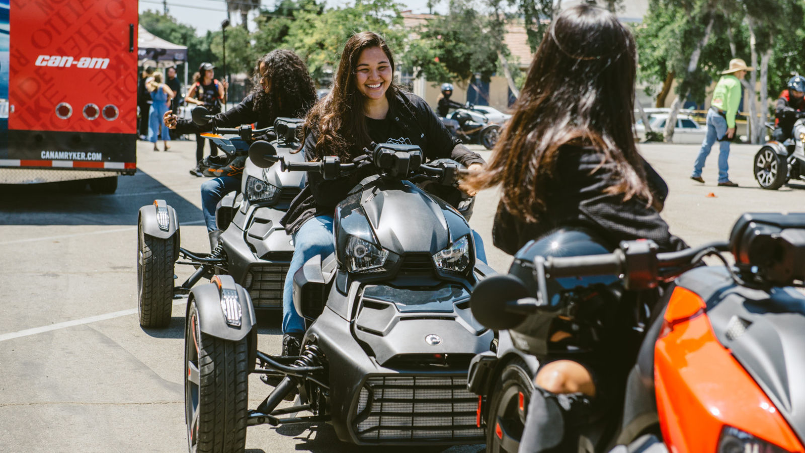 Three women riders and their vehicles