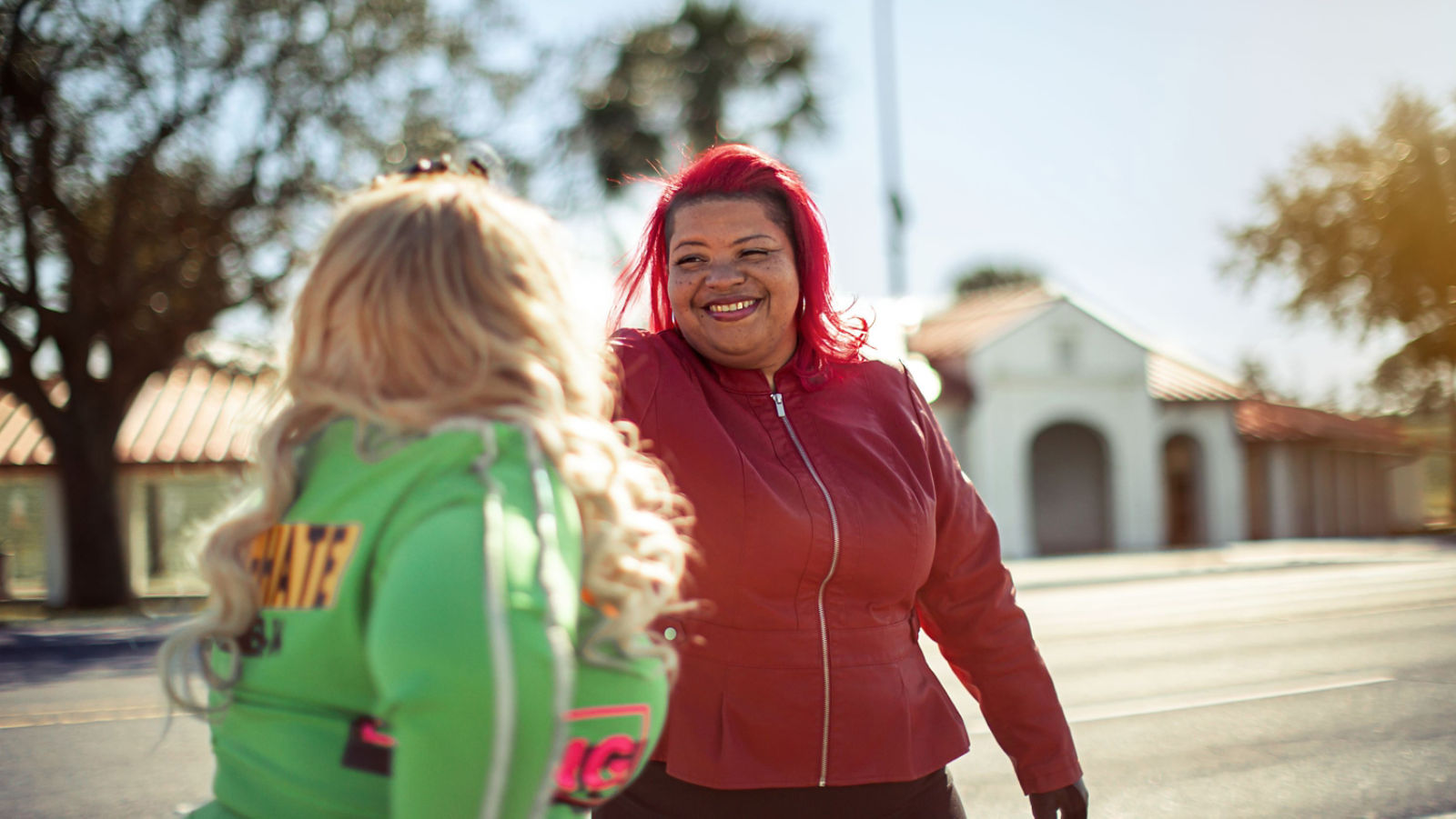 Two women riders smiling at each other