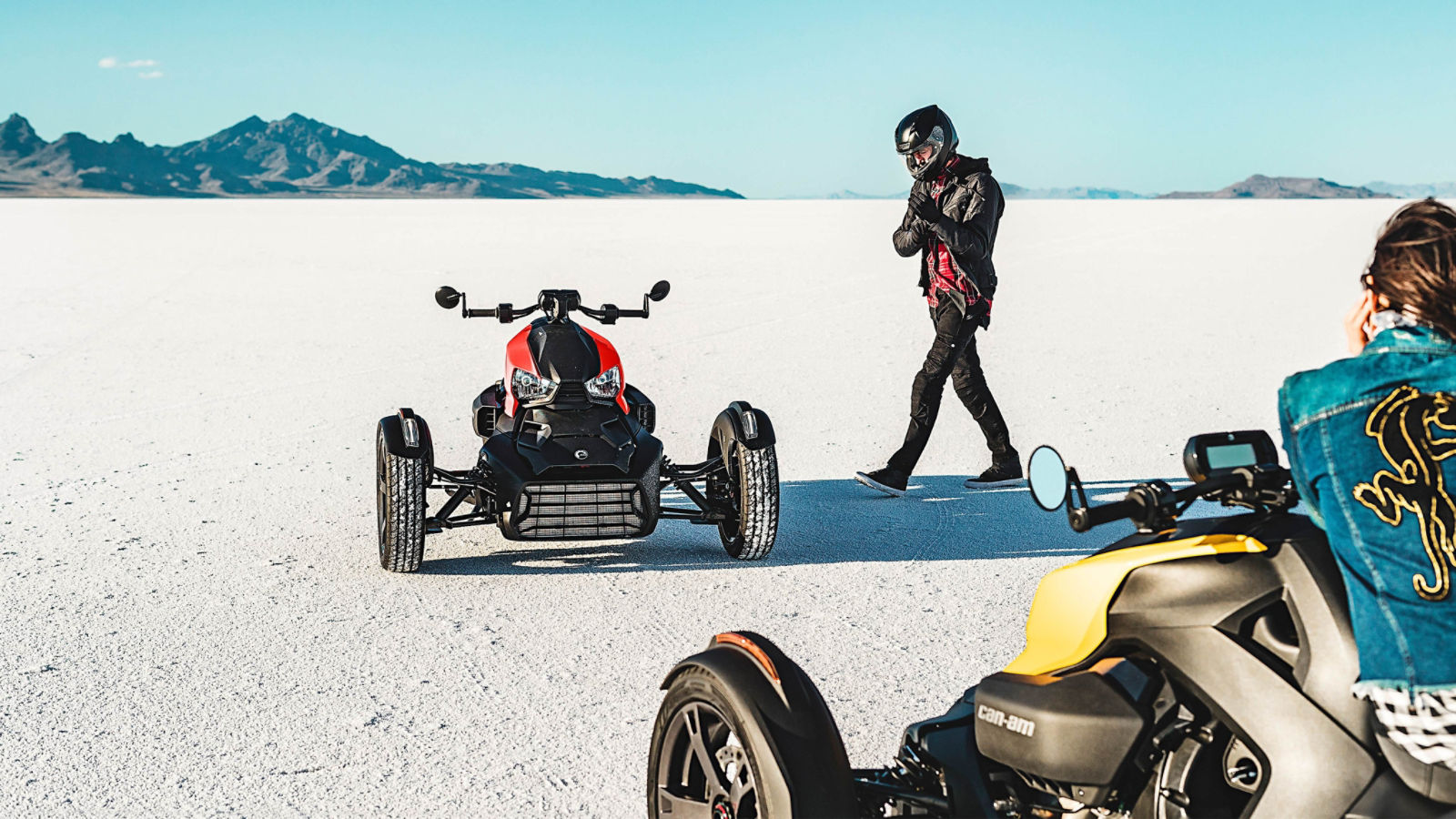 Man walking towards Can-Am Ryker vehicle with adrenaline red panels