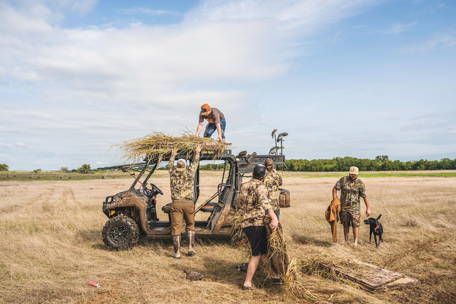 Hunters walking to a Can-Am hunting vehicle 