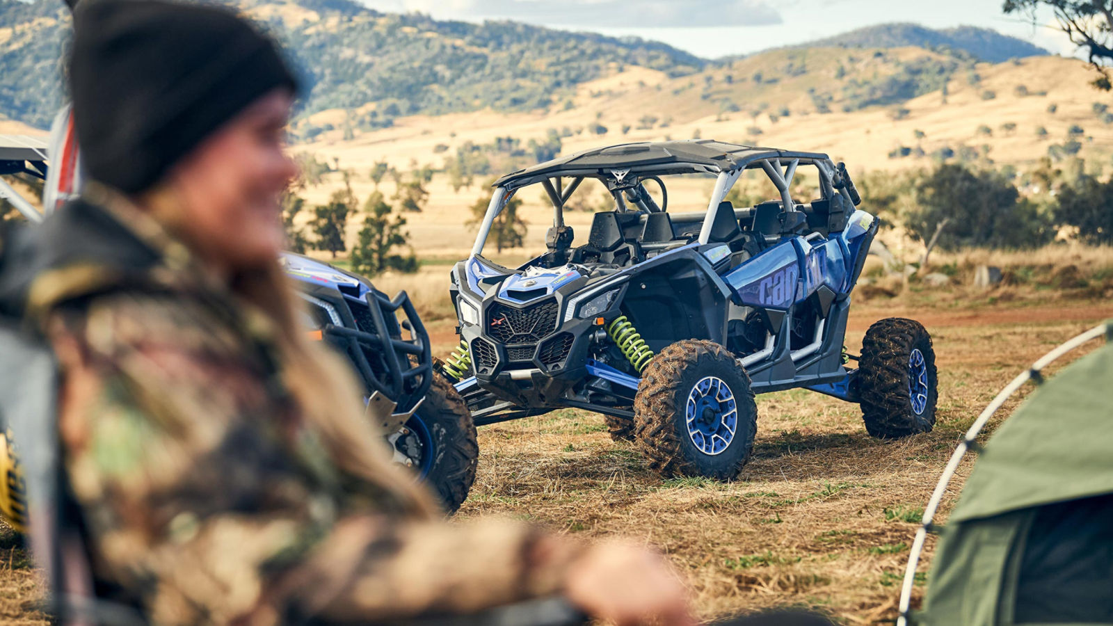 A rider and a parked Can-Am SxS 
