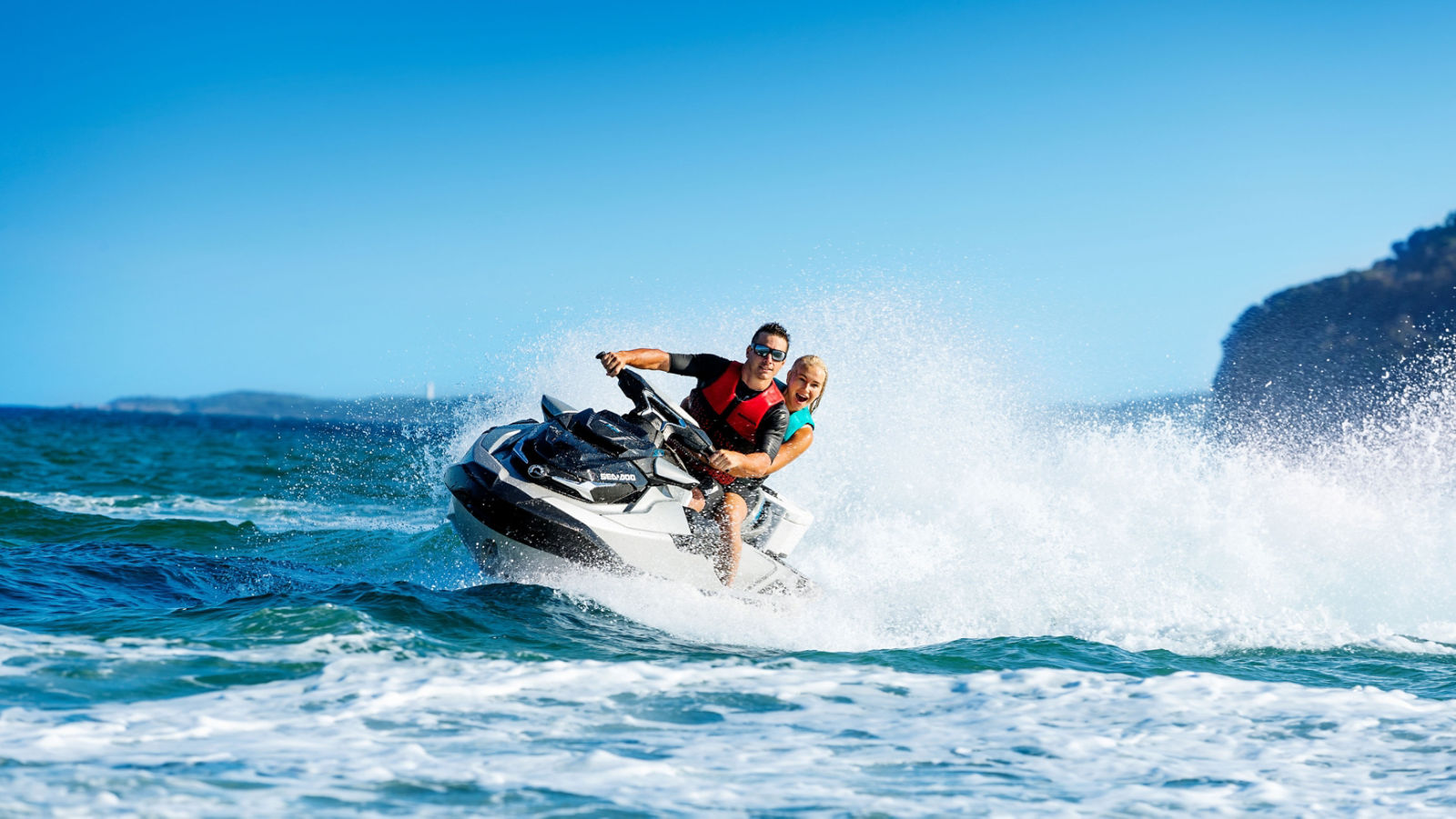 Couple having fun riding a Sea-Doo GTX Limited