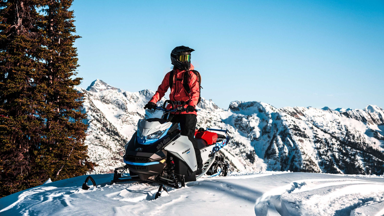 Woman on her Ski-Doo Summit Edge on the top of a mountain