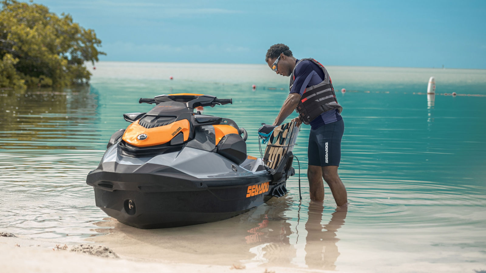 Man fixing wakeboard on the Sea-Doo GTI SE
