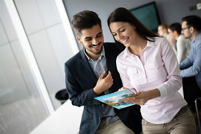 Two individuals reviewing a mail piece