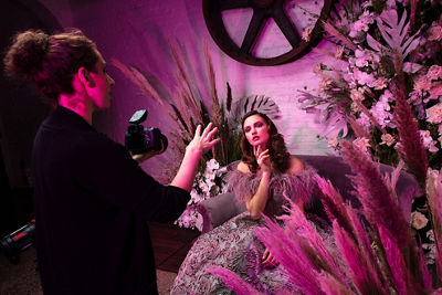 Behind the scenes shot of photographer talking to the model