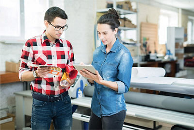 A man and woman discussing a print job