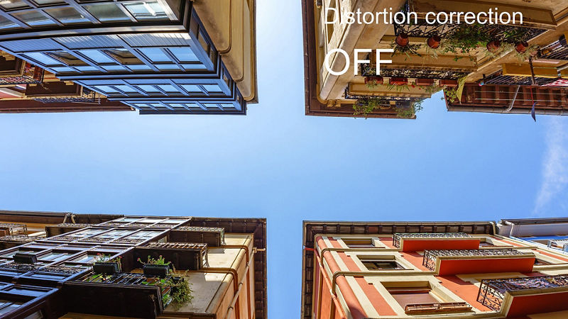Upward view of buildings showing distortion without correction
