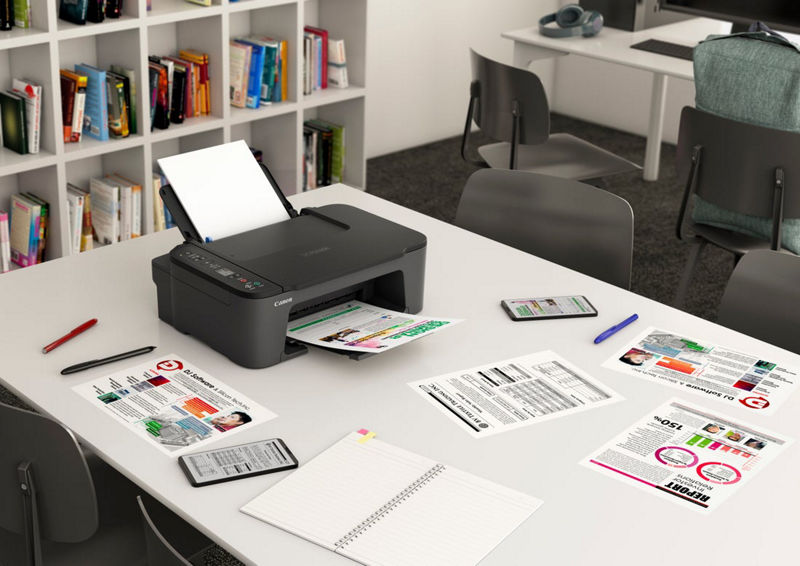 Imprimante PIXMA TS3720 sur la table de bureau entourée de fichiers imprimés