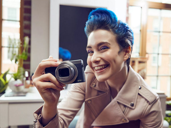 Woman smiling and holding a camera