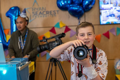 Child Using Canon Camera to Take a Picture