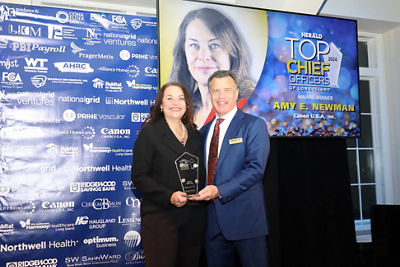 Amy Newman being presented with 2024 HERALD Top Chief Officers of Long Island Award