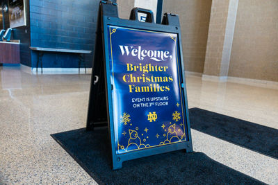 Stand outside of venue that says Welcome Brighter Chistmas Families