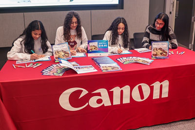 Candlewood Middle School Students holding a book Signing for parents and teachers