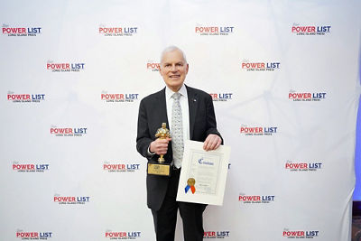 Seymoure Liebman holding award for LI Power List and certificate