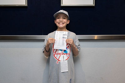 Francis Gomez (Pediatric Patient) holding the Players Line-up Card