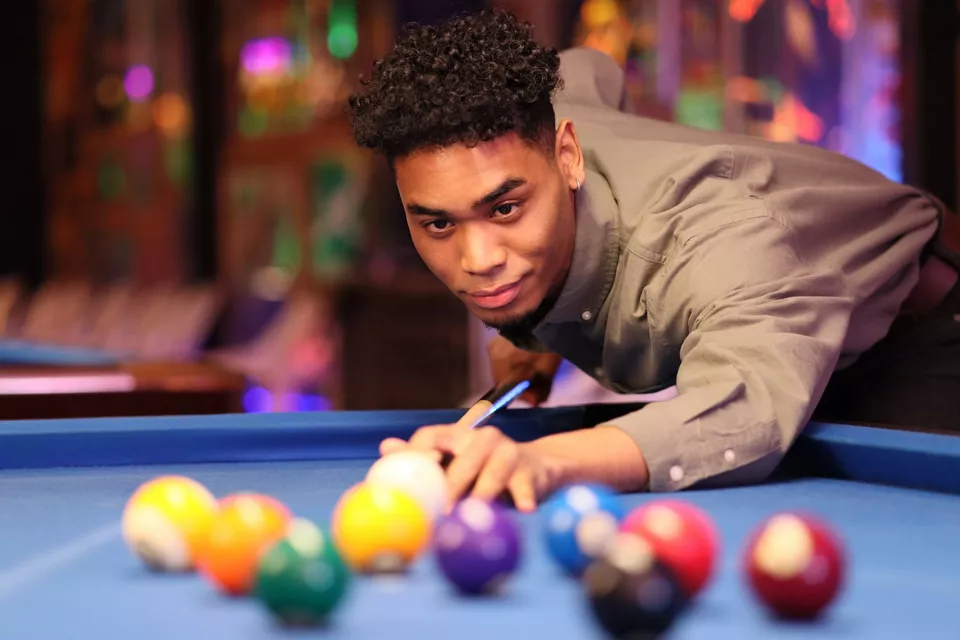 Person Getting Ready to Take A Shot in a Billiards Table