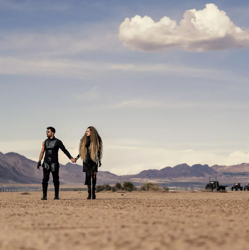 Couple Walking in a Desert While Holding Hands