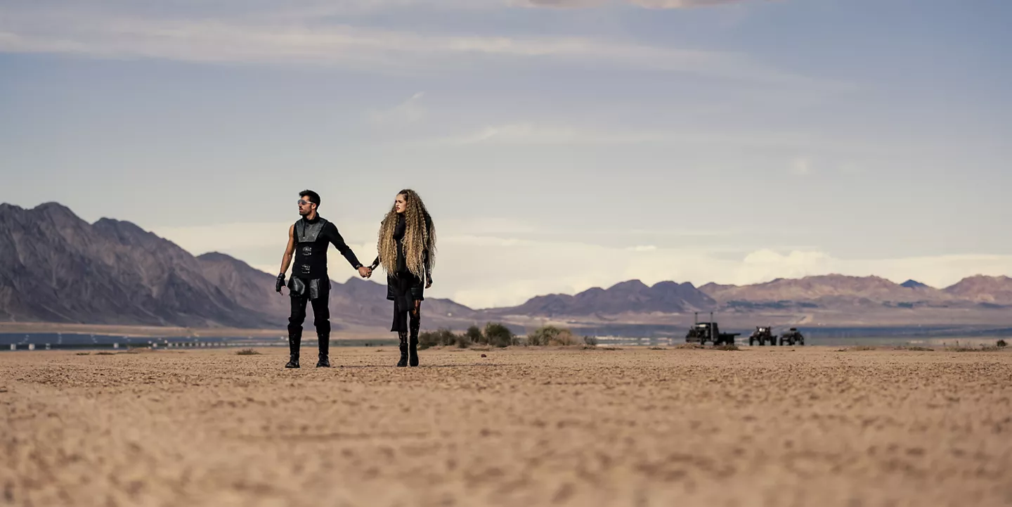 Couple Walking in a Desert While Holding Hands