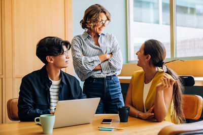 Three business professionals confering at a table