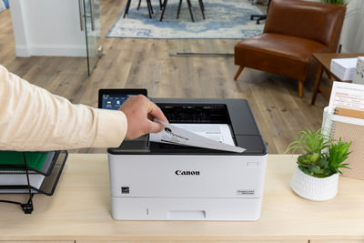 Person Taking Printed Paper From Canon Printer