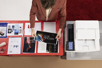 Person Getting Printed Paper From Canon Printer