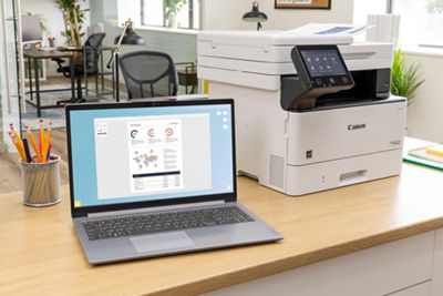Canon Printer Next to Laptop on an Office Desk