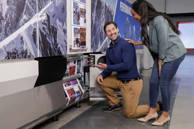 Man and Woman working of ProStream printer