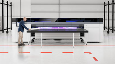 Man standing next to Colorado printer