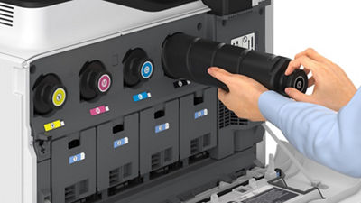 man changing toner on a Canon printer