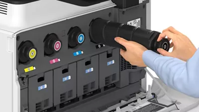 man changing a toner on a Canon printer