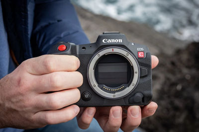 Person holding an EOS R5 C body