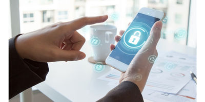 Person with mobile device showing security seal and documents in background