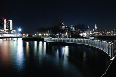 Night image of walking bridge and cityscape