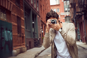 Man in an alley taking picture