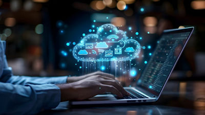 man working on laptop with cloud icon in background