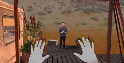 virtual environment showing users virtual hands and man in the distance