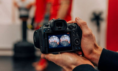 Holding the EOS VR camera and lens