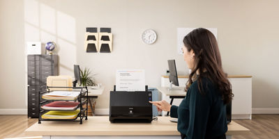 Women at a desk using an imageFORMULA