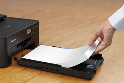 Paper being loaded into the PIXMA TS702a's paper tray