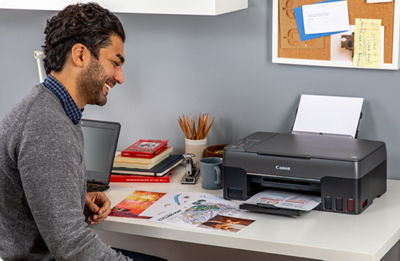 PIXMA G3262 - Person Printing Flyer