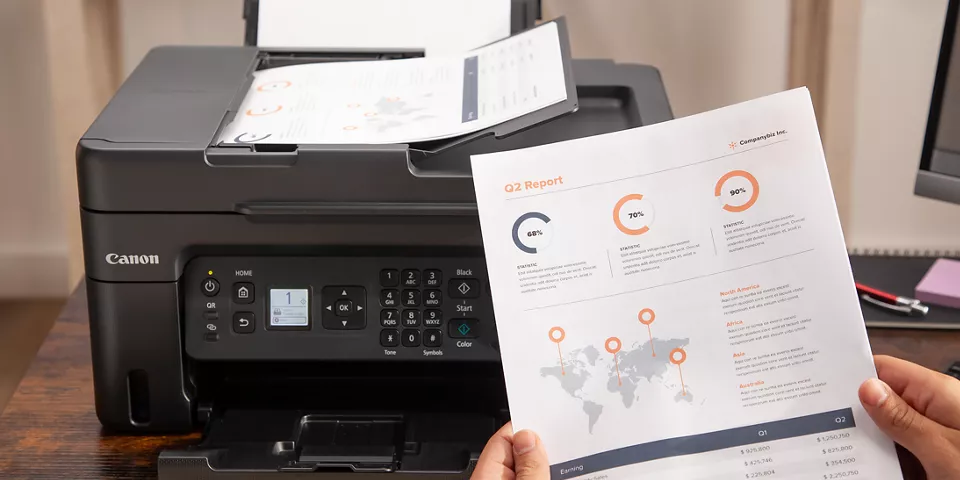 A person viewing their printed sheet of information from the PIXMA G4270