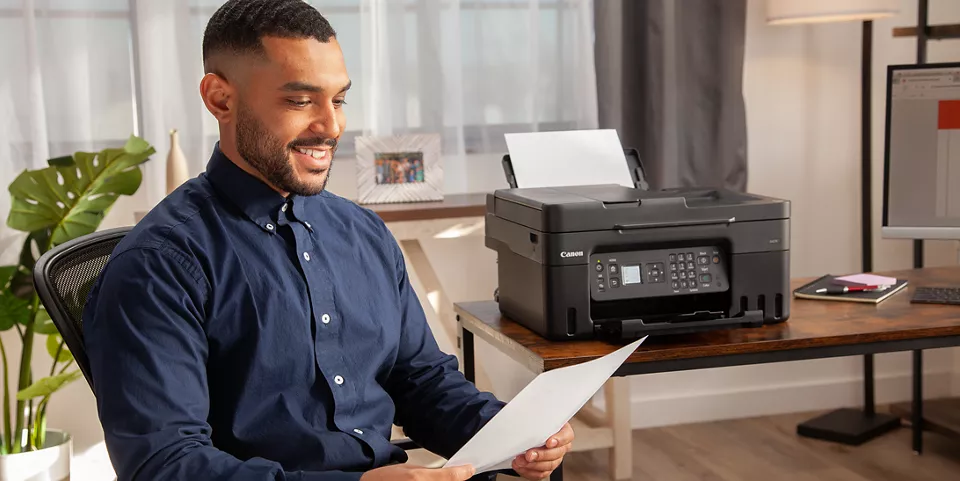 Person smiling at their print, printed from the PIXMA G4270 Printer