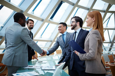 Image of people in a business meeting shaking hands
