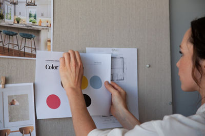 Person Pinning Up a Paper