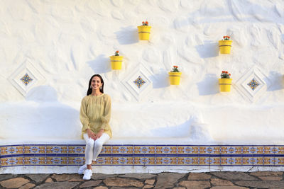 Personal in Front of White Stone Wall