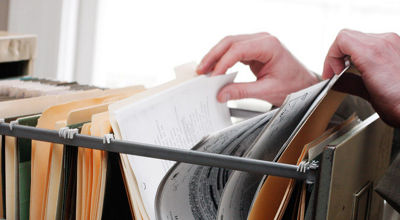 Hands working in a filing cabinet