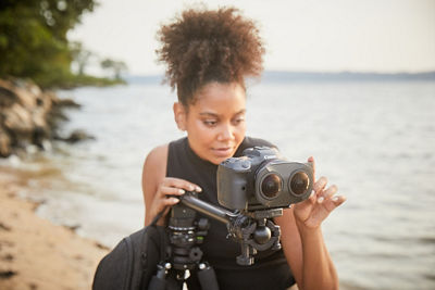 Woman on beach with lens